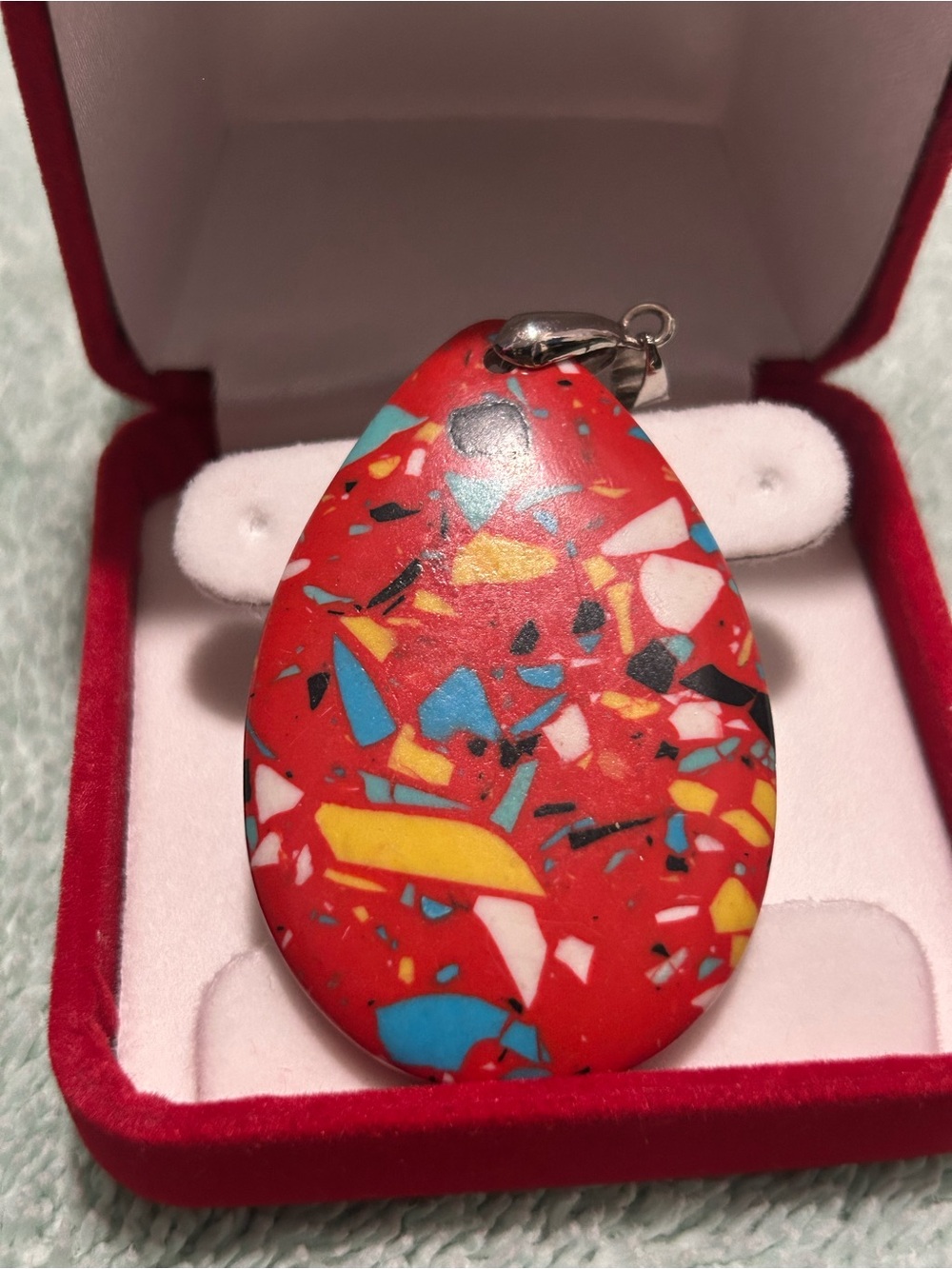 teardrop-shaped pendant featuring a red matrix turquoise mosaic design